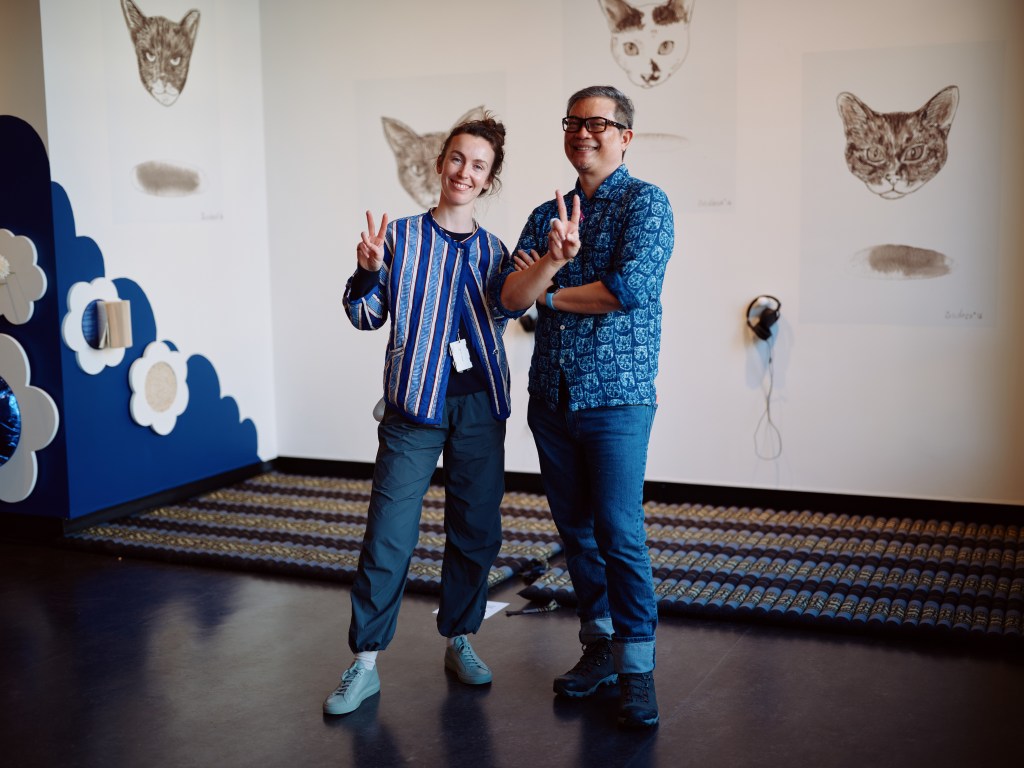 Nicola and Vipoo pose in exhibition space